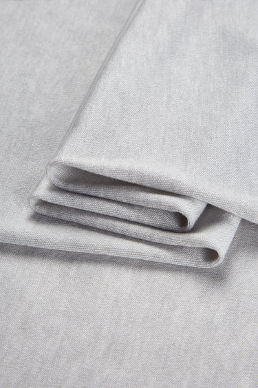 TENCEL wool blend interlock fabric close-up with folded stack detail for next-to-skin comfort and lightweight knitwear.