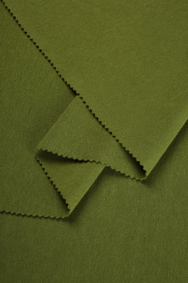 Merino cashmere blend mousse knit fabric close-up with layered fold detail for casualwear and comfortable knit garments.