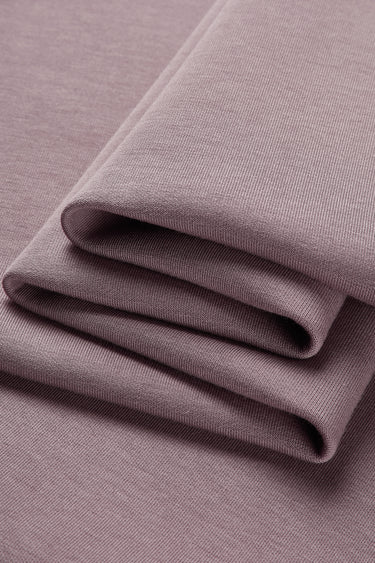 HEAT-FLOW fleece knit fabric close-up with folded drape detail for modern cold-weather knitwear.