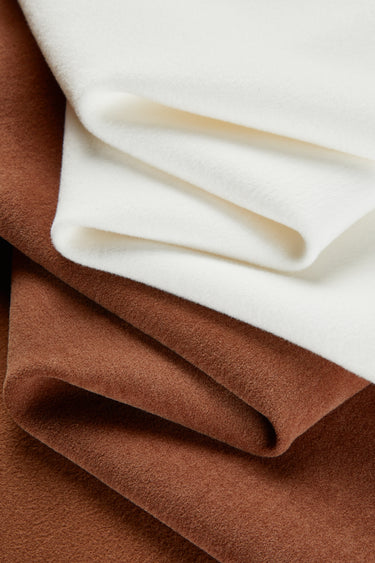 HEAT-FLOW fleece knit fabric close-up with backing fold detail for warm hoodies and thermal tops.