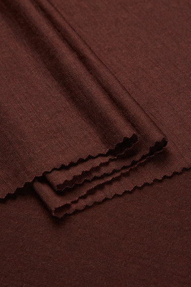 TENCEL wool blend single jersey fabric close-up with folded edge detail for breathable base layers and everyday knitwear.