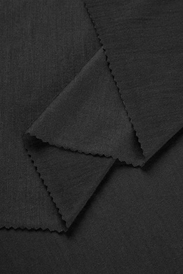TENCEL wool blend single jersey fabric close-up with layered fold detail for next-to-skin comfort and soft knit garments.