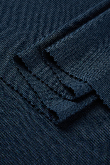 TENCEL wool blend rib knit fabric close-up with folded edge detail and soft dry touch for everyday knitwear.