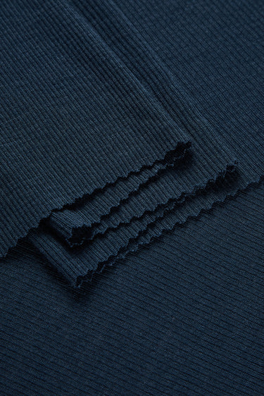 TENCEL wool blend rib knit fabric close-up with layered fold detail for premium base layers and soft knit garments.
