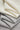 Mousse rib knit fabric close-up with folded drape detail for casualwear and comfortable knit garments.