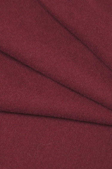 Wool blend mousse knit fabric close-up with diagonal fold detail and smooth hand feel for comfortable knit garments.