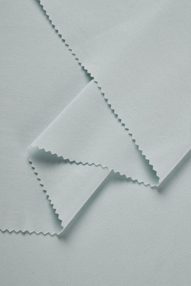 Mousse rib knit fabric close-up with layered fold detail for soft casualwear and comfortable knit garments.