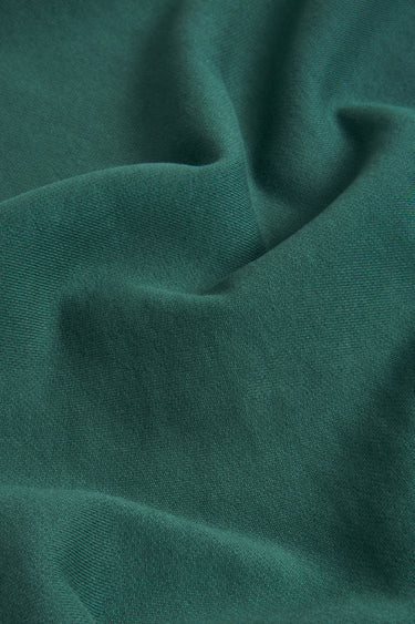 Sand-washed stretch double knit fabric close-up with twist detail and refined texture for everyday lifestyle garments.
