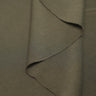 Sand-washed rib knit fabric close-up with layered fold detail for modern knitwear and everyday lifestyle garments.