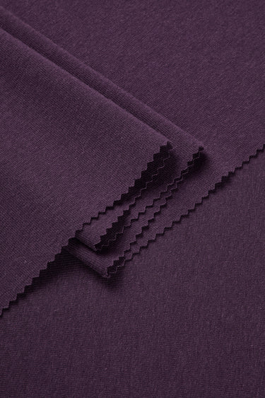 Mousse rib knit fabric close-up with folded detail and smooth hand feel for comfortable knit garments.