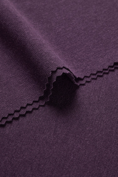 Mousse rib knit fabric close-up with rolled edge detail and soft micro-fleece surface for casual knitwear.