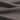 Grey taupe cashmere wool blend knit fabric close-up with fine rib texture and soft drape for luxury knitwear.