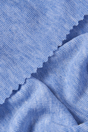 Lycra TENCEL wool stretch rib knit fabric close-up with edge structure detail and smooth texture for breathable everyday knitwear.
