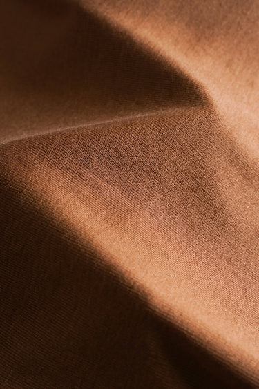 TENCEL wool blend stretch rib knit fabric close-up with diagonal fold detail and smooth texture for lightweight knitwear.